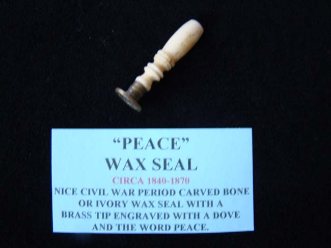 A 19th century miniature bone handled wax seal with the word PEACE over a dove